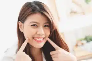 Person pointing at their mouth