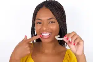 Person holding clear orthodontic aligner