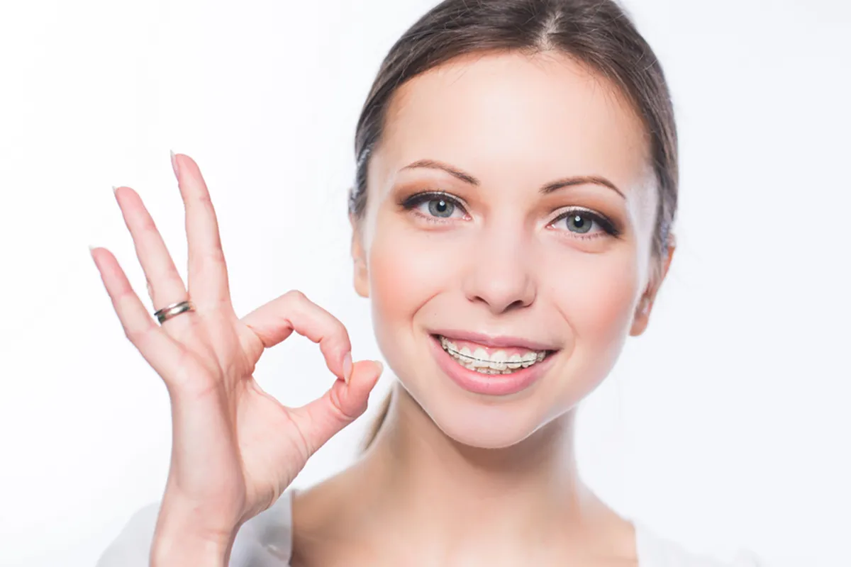 easier-hygiene teen with braces on phone