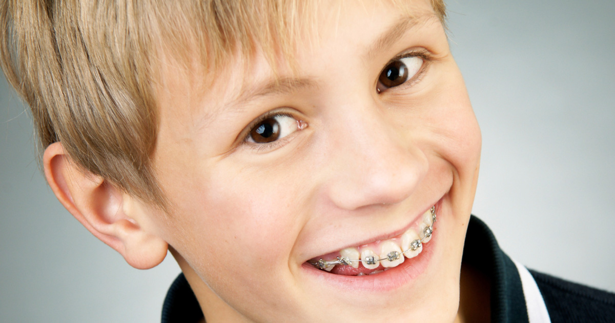 kid-with-braces teen with braces on phone