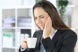 Person holding a cup in office