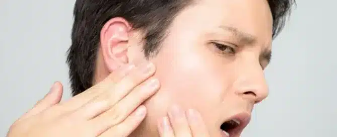 Person touching their face gently