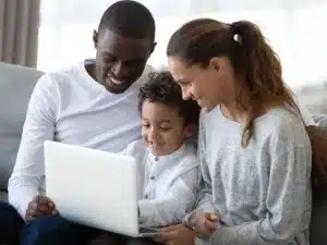 Family using laptop together at home