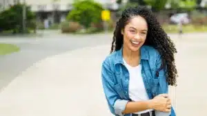 Person with curly hair outdoors