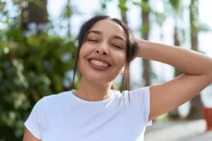 Person posing outdoors with blurred face