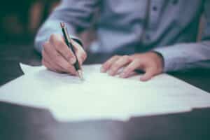 man at desk with pen and insurance documents