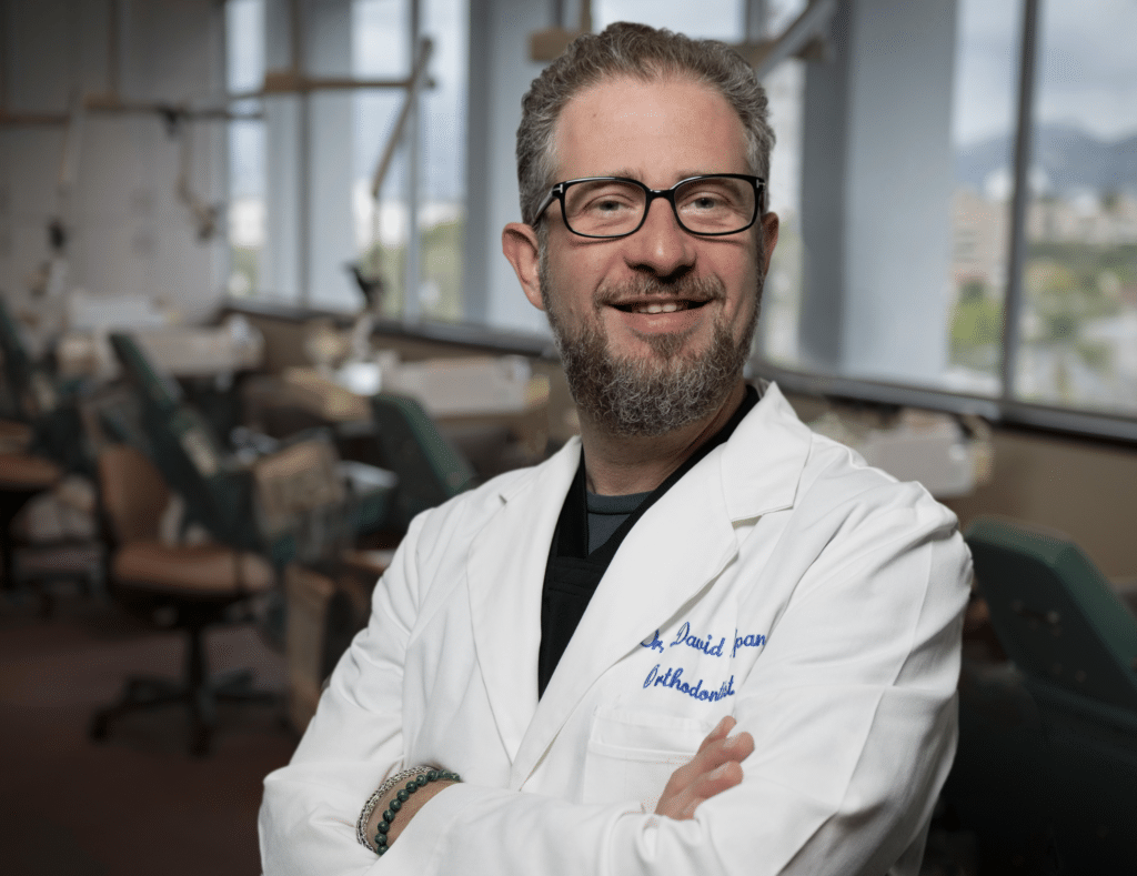 Person in lab coat, dental office