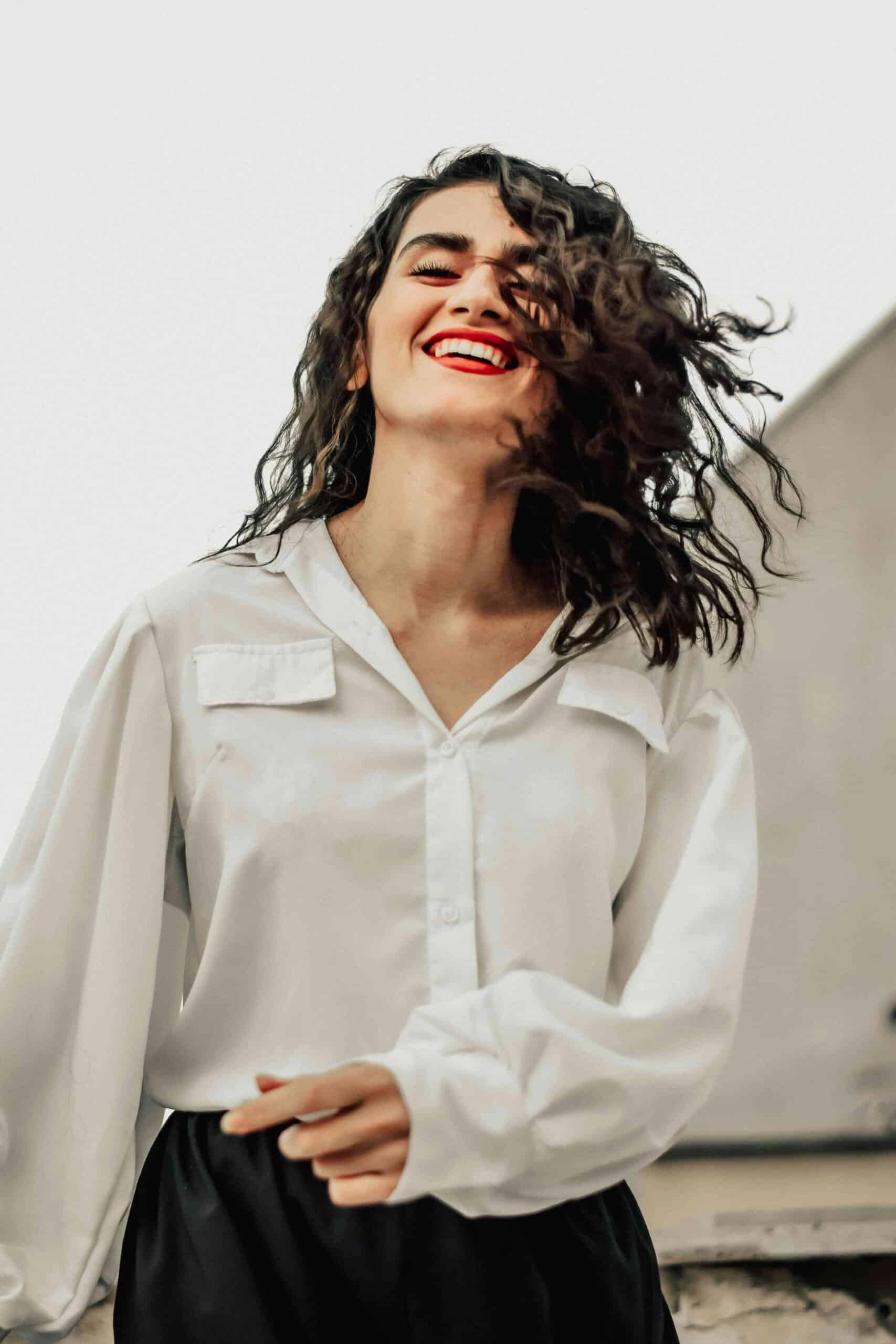 woman in white dress shirt smiling