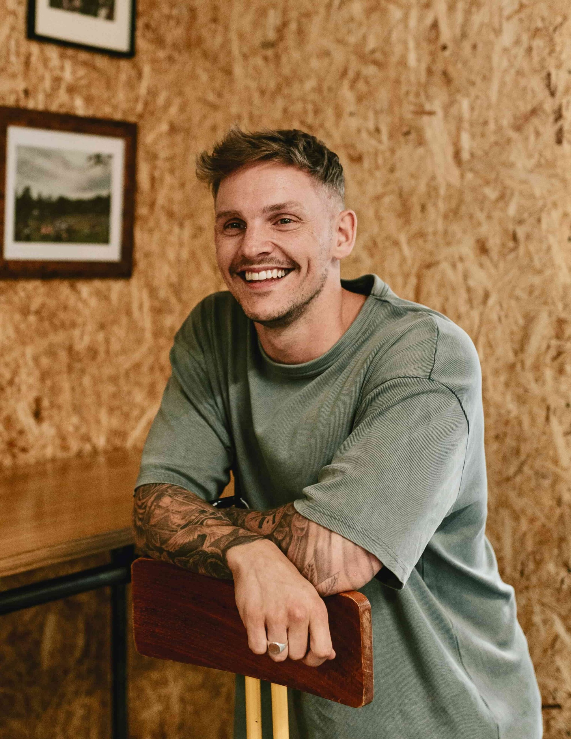 man with bright smile in green shirt