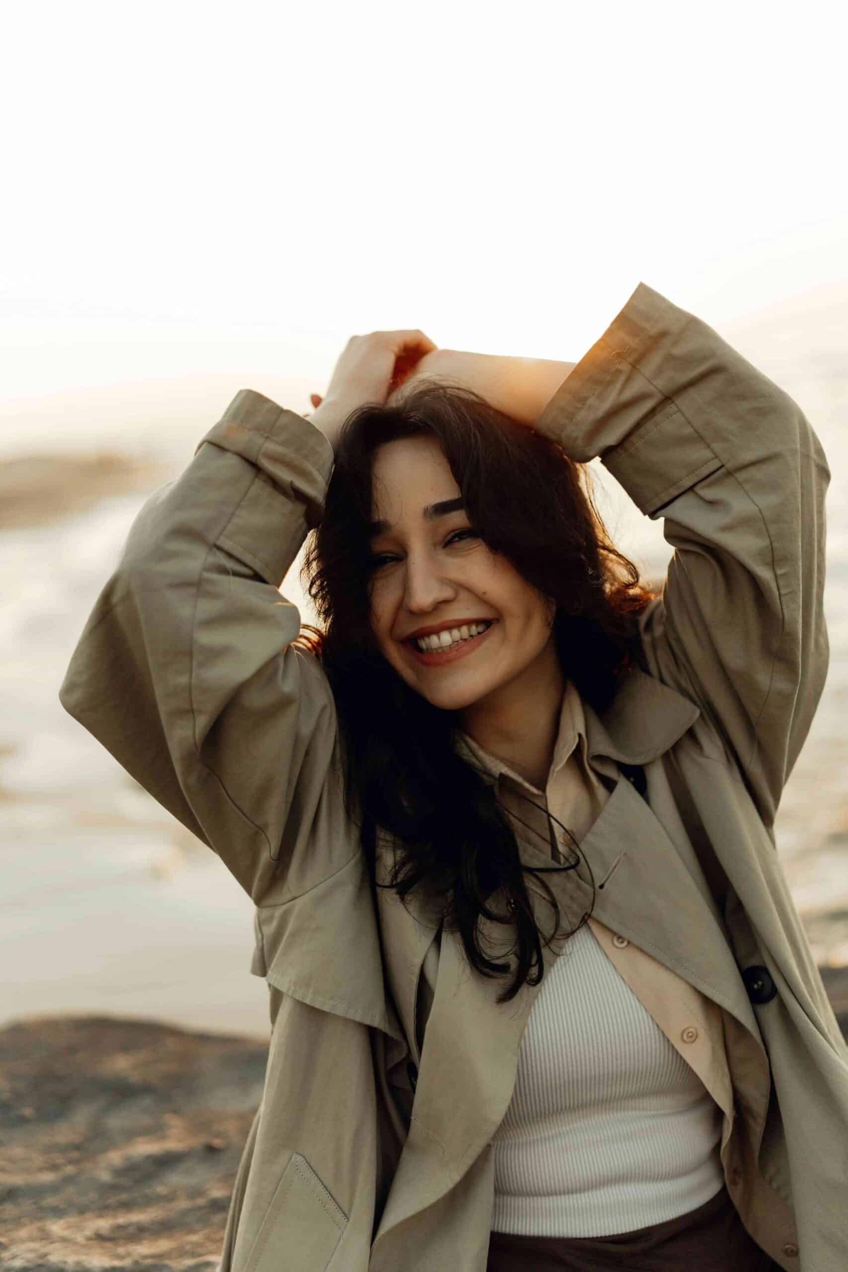 Will Shaving Teeth For Braces Help? What You Need to Know 5 girl at the beach with hand up and smiling