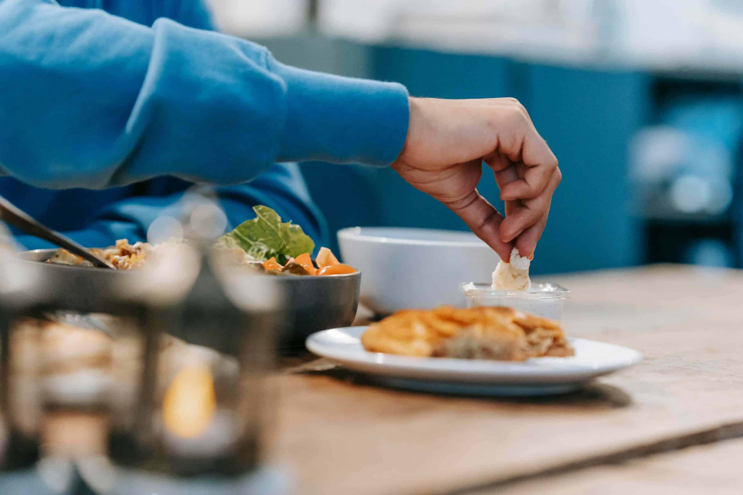 hand picking up food