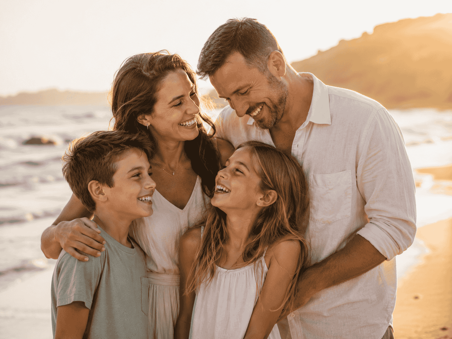 family photo at the beach with big beautiful smiles