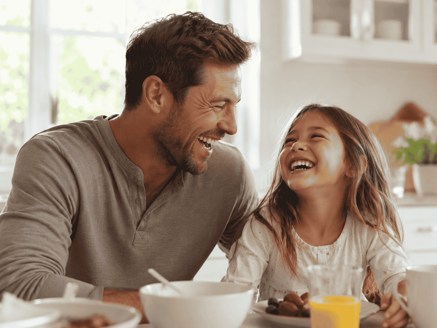 father and daughter laughing over lunch