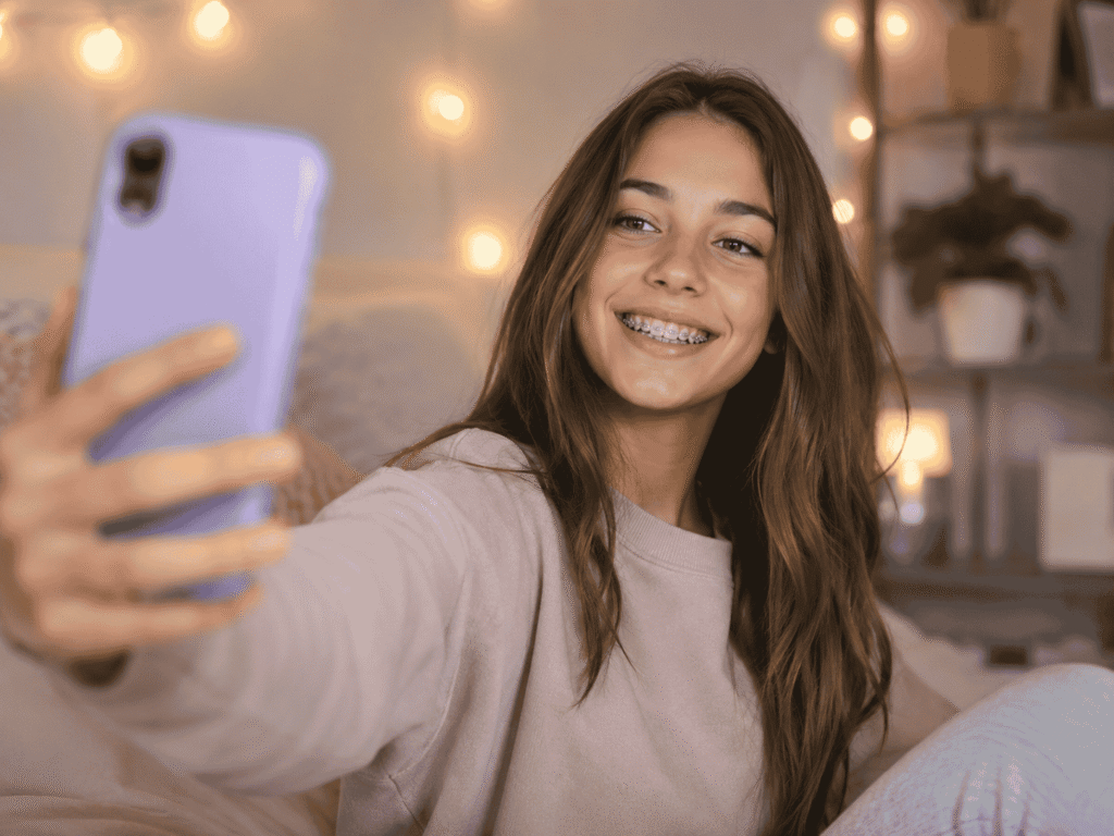 teen with braces taking selfie